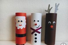 three toilet paper roll crafts with santa, snowman and reindeer faces on the top