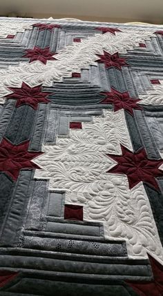 a quilted bed with red and white stars on it