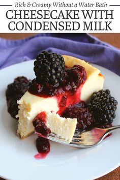 a piece of cheesecake with berries on top is sitting on a plate next to a fork