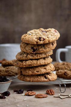 a stack of cookies sitting on top of a metal rack next to a cup of coffee