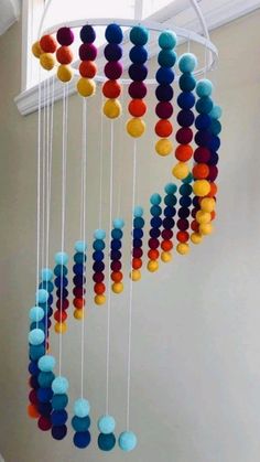 a wind chime with multi colored balls hanging from it