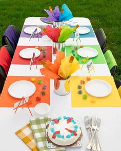 the table is set with colorful napkins and plates