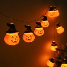 a string of halloween lights with jack - o'- lanterns hanging from them