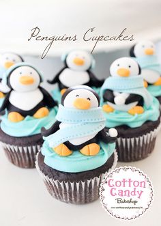 cupcakes decorated with penguins in blue and white frosting