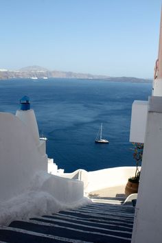 stairs leading up to the water with boats in the background