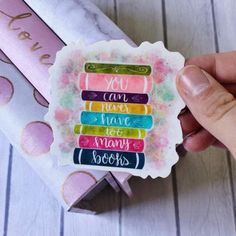 a hand holding a sticker with the words you can have many books on it