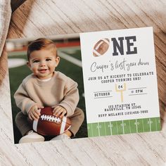 a football themed first birthday party card with a photo of a baby holding a football