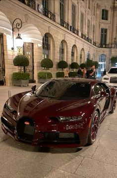 a bugatti car parked on the street in front of a building