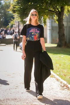 Tuck a vintage tee (also borrowed from Dad?) into a pair of his high-waisted trousers. MSGM High Waisted Wide Leg Trousers, $311.67, available at Farfetch. Black T Shirt And Pants Outfit, Casual Black Dress Pants Outfits, Styling Dress Pants Casual, Black Pants Styling, Black Casual Pants Outfit, Tshirt With Dress Pants, Classy Hoodie Outfit, Tshirt And Pants Outfit Women, Black Wide Pants Outfit Casual