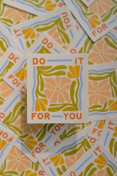 some stickers that say do it for you on top of a table with orange and green designs