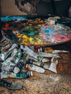 the table is covered with paint and other items that have been left on it for painting