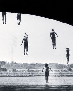 several people are floating in the water under an overpass with their feet up and hands out