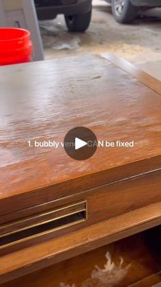 a close up of a wooden table with drawers