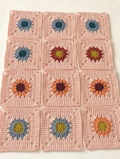 a crocheted square with flowers on it