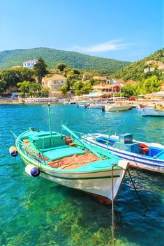 two boats are docked in the clear blue water