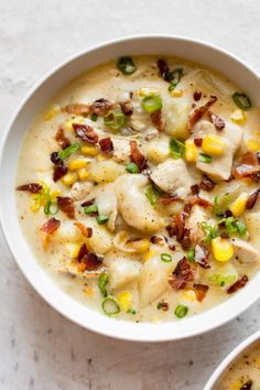 two white bowls filled with food on top of a table