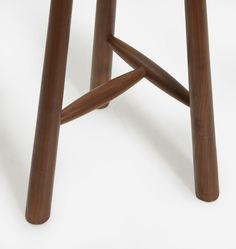 a close up of a wooden stool on a white background with no people around it