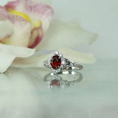 Oval red spinel ring is stunning. Natural spinel gemstone weighs 1.1 carats and has amazing clarity and sparkle. The color of this gemstone is a brilliant red.  Oval red spinel ring has both grace and style. Bonded with rhodium to prevent tarnish. A perfect choice for those with an active lifestyle. Spinel is very durable and handles day to day wear and tear beautifully. Spinel is an 8 on the harness scale comparable in durability to a sapphire. This gem is not treated in any way. Spinel is a st Oval Ruby Ring For Wedding And Promise, Elegant Garnet Gemstone Ring, Garnet Birthstone Ring With Accent Stones, Exquisite Ruby Ring With Gemstone Accents For Anniversary, Elegant Rings With Lab-created Ruby And Accent Stones, Heirloom Style Red Garnet Cluster Ring, Heirloom Red Garnet Cluster Ring, Fine Jewelry Red Garnet Cluster Ring, Fine Jewelry Garnet Cluster Ring In Red