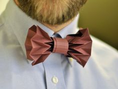 a close up of a man wearing a bow tie