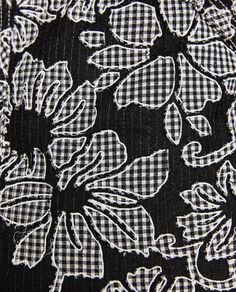 a black and white floral print fabric with gingham checkered pattern on it