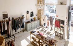 a clothing store with clothes hanging on racks