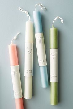 three different colored candles sitting next to each other