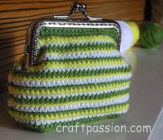 a green and white purse sitting on top of a table