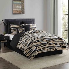 a bed with black and white comforters in a room