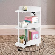 a small white shelf with books on it