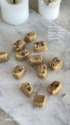 several pieces of cake sitting on top of a marble counter