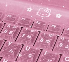 an image of a pink keyboard with hello kitty on the keys and stars in the background