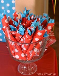 a glass bowl filled with red and white paper