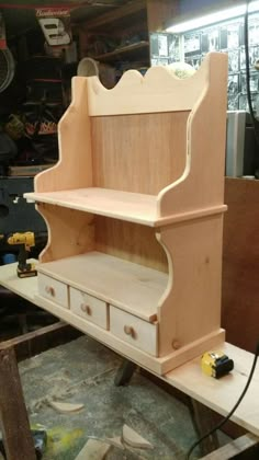 a wooden shelf sitting on top of a workbench