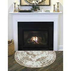 a living room with a fire place and rug on the floor