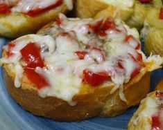 small pizzas with cheese and sauce on a blue plate