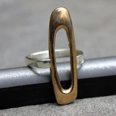 Modern Oval Sterling Silver Signet Ring, Modernist Open Ring For Everyday, Everyday Modernist Open Ring, Modernist Oval Sterling Silver Ring, Modern Oval Stackable Rings For Formal Occasions, Modern Open Band Rings With Polished Finish, Modern Oval Stackable Rings With Polished Finish, Modern Oval Link Rings For Everyday, Modern Oblong Jewelry With Polished Finish