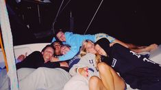 a group of people laying on top of a boat