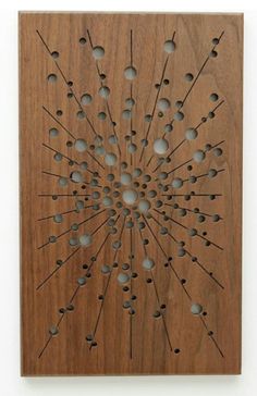 a wooden wall hanging with holes in the center and arrows on it's side