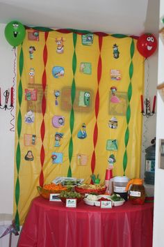 a table topped with lots of food and balloons