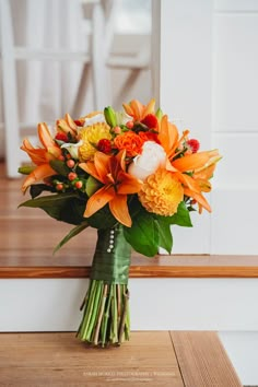 a bouquet of flowers sitting on top of a wooden table