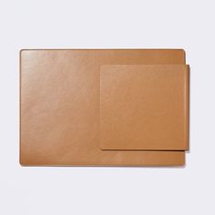 two brown leather folders sitting on top of each other