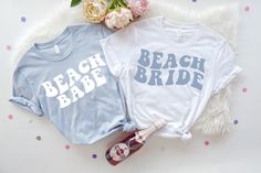 two t - shirts that say beach babe and beach bride on them next to flowers