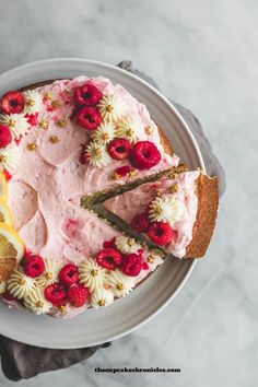 a cake with raspberry frosting and lemon wedges