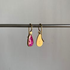 Organic in form, these rubies are packed with lush and lively pink personality. 18k yellow gold Rubies, 2.53ctw, 7mm x 12mm (1/4" x 1/2") Earrings hang 15/16" from the ear Each earring weighs 1.3g Single Pink 14k Gold Earring, Pink Oval Ruby Earrings, Teardrop Ruby Jewelry In Yellow Gold, Rose Gold Pink Sapphire Earrings As Gift, Rose Gold Pink Sapphire Earrings For Gift, Pink Brass Earrings As Gift, Pink Brass Earrings For Gifts, Ruby Earrings In Yellow Gold For Gift, Pink Ruby Drop Earrings