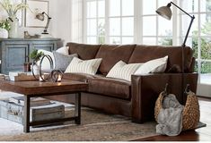 a living room filled with lots of furniture and decor on top of a wooden floor