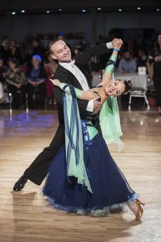 a man and woman dancing on a dance floor