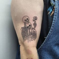 a person with a skeleton tattoo on their arm