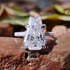 a diamond ring sitting on top of a rock