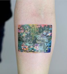 a tattoo with water lilies on the side of its arm and it's reflection