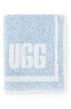 a blue and white rug with the ugg logo on it, against a white background